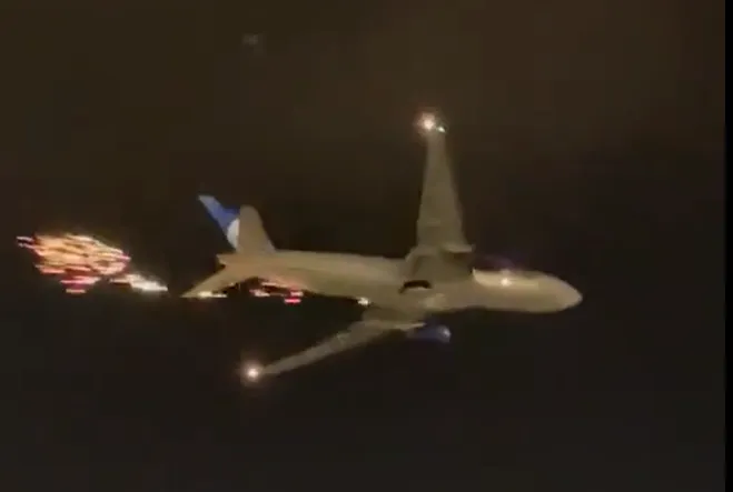 UNITED AIRLINES 777 SHEDS SPARKS AND DEBRIS ON TAKE-OFF